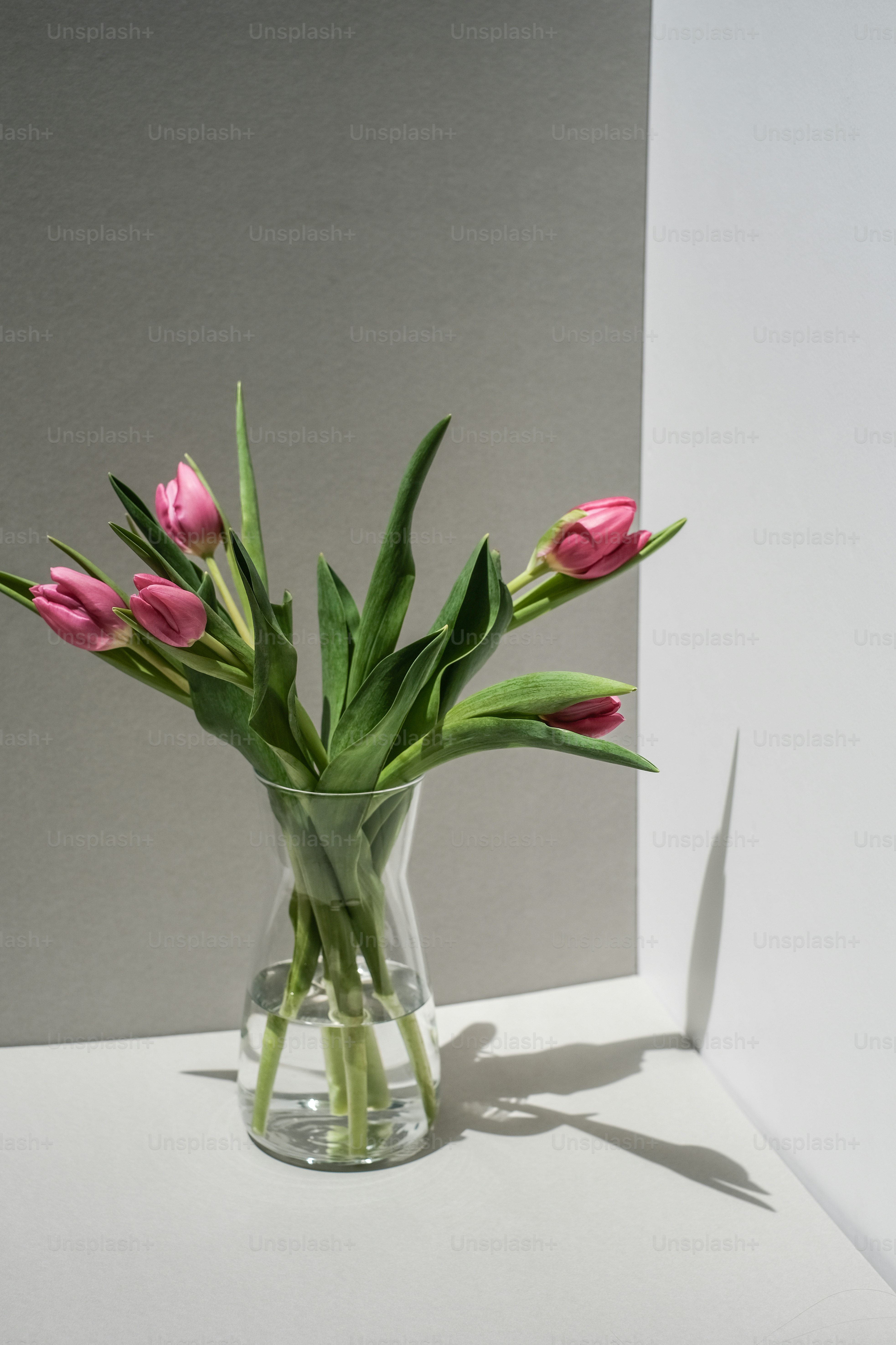 a vase filled with pink flowers on top of a table
