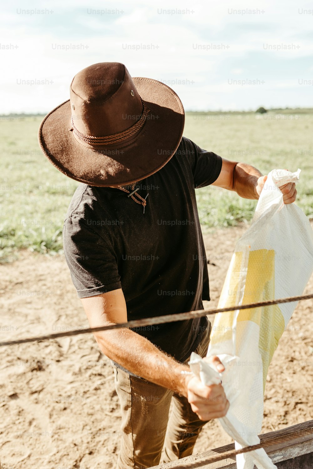 a man in a hat is holding a bag