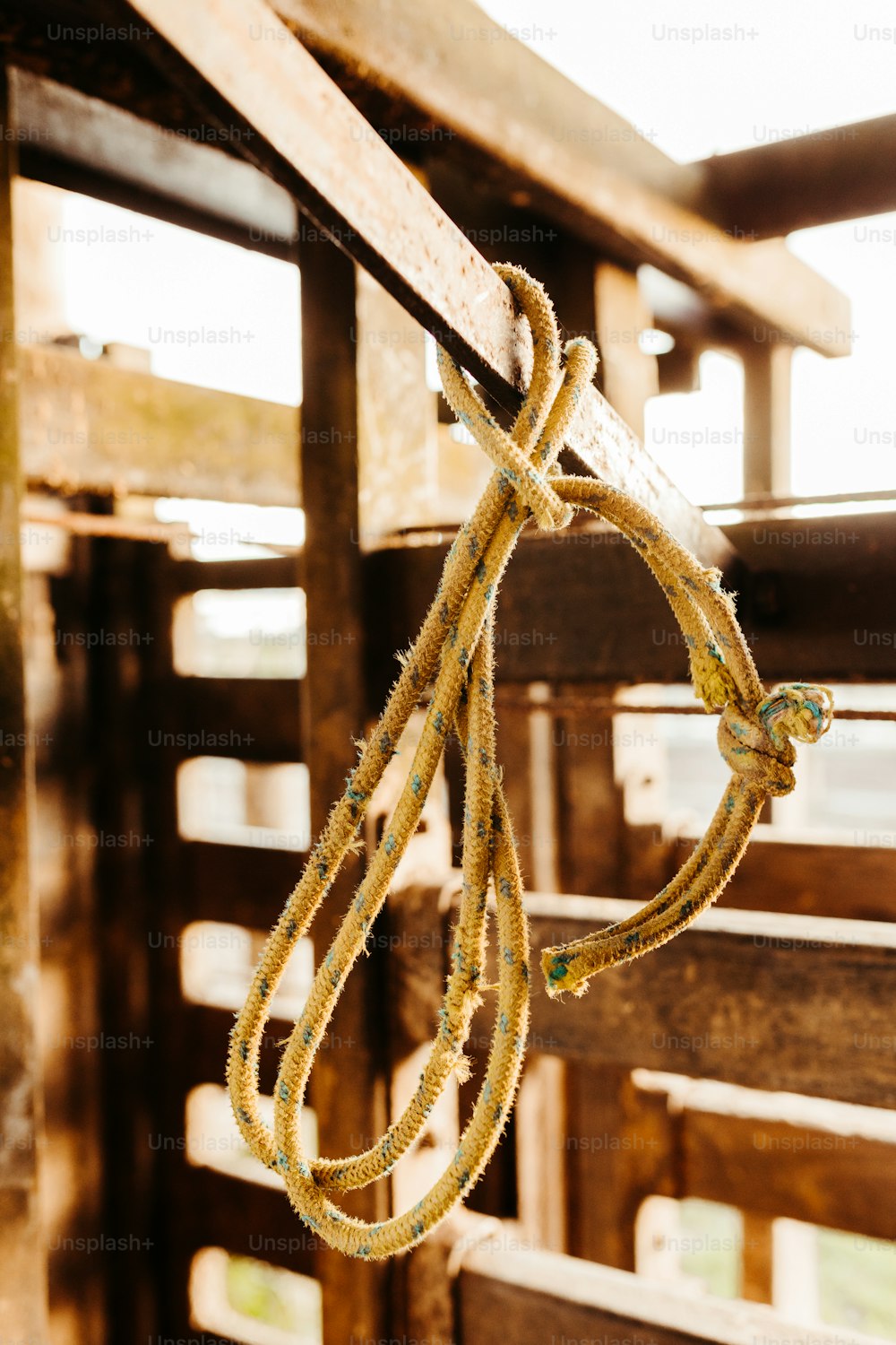 a rope hanging from the side of a wooden fence