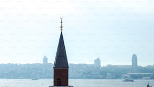 a church steeple with a view of a city in the background