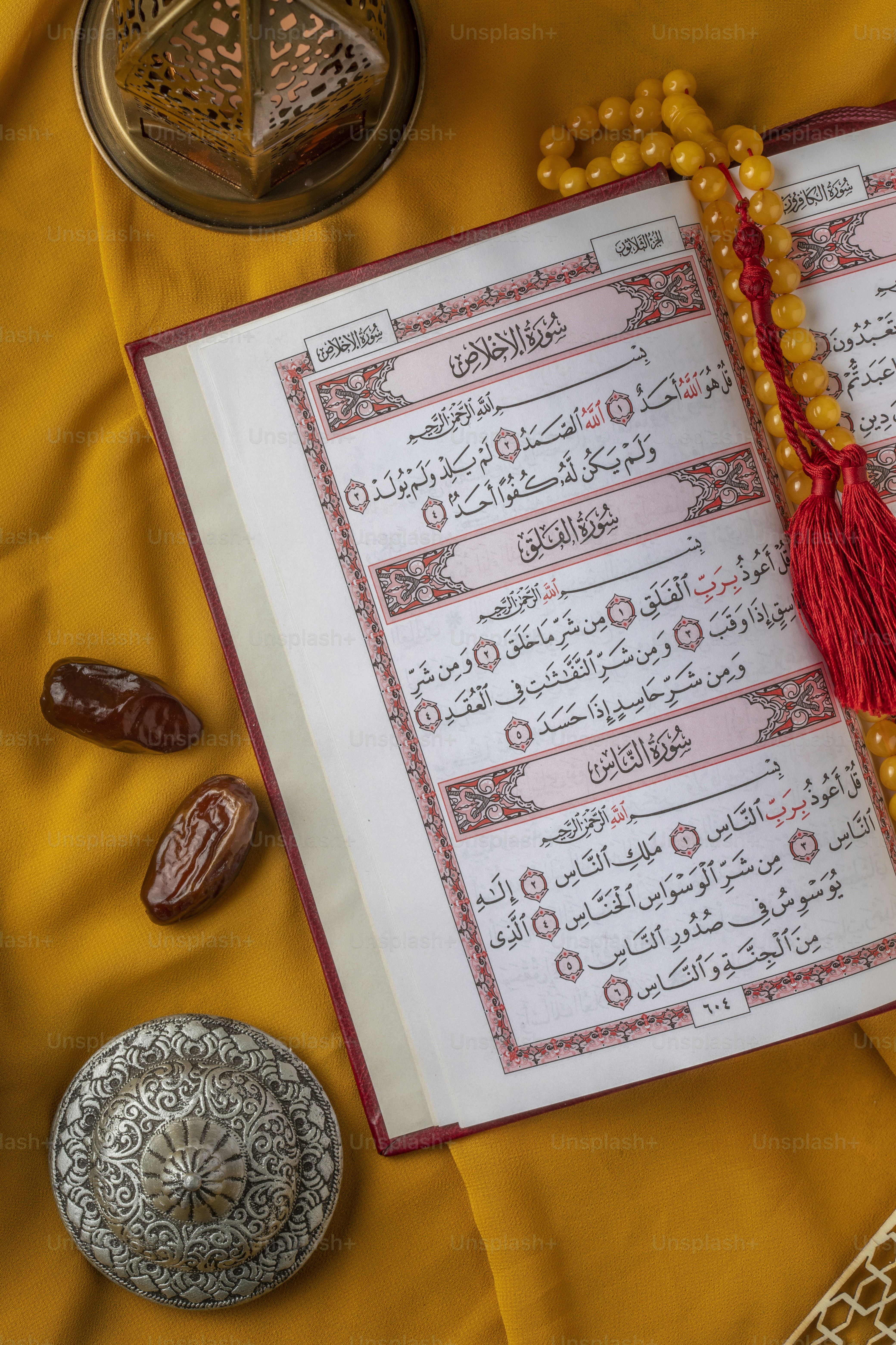 an open book with a tassel on top of it