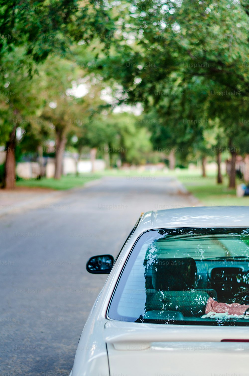 a white car parked on the side of a road