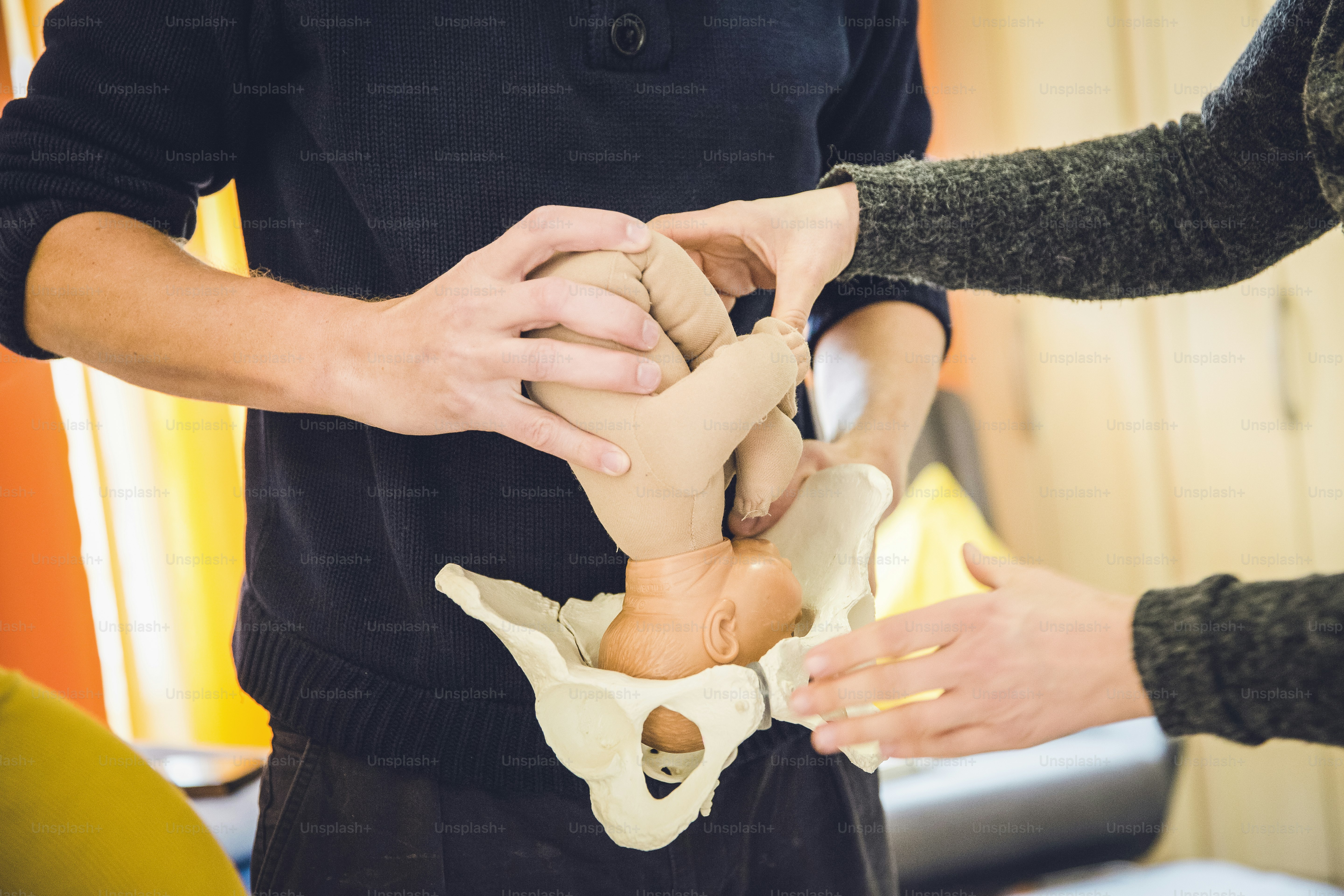 a person is holding a fake animal in their hands