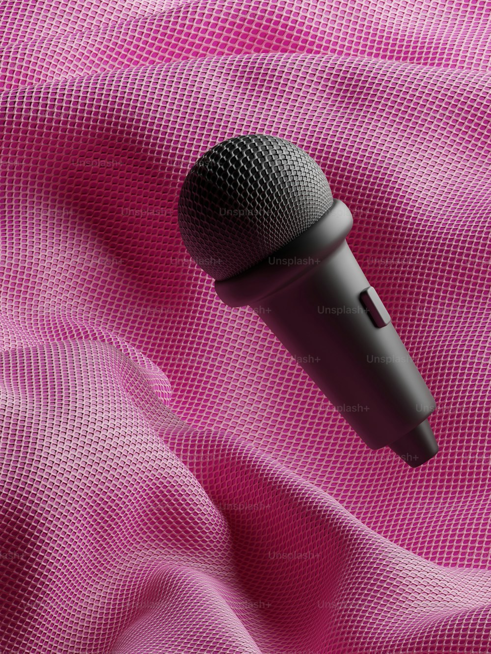 a microphone on a pink fabric