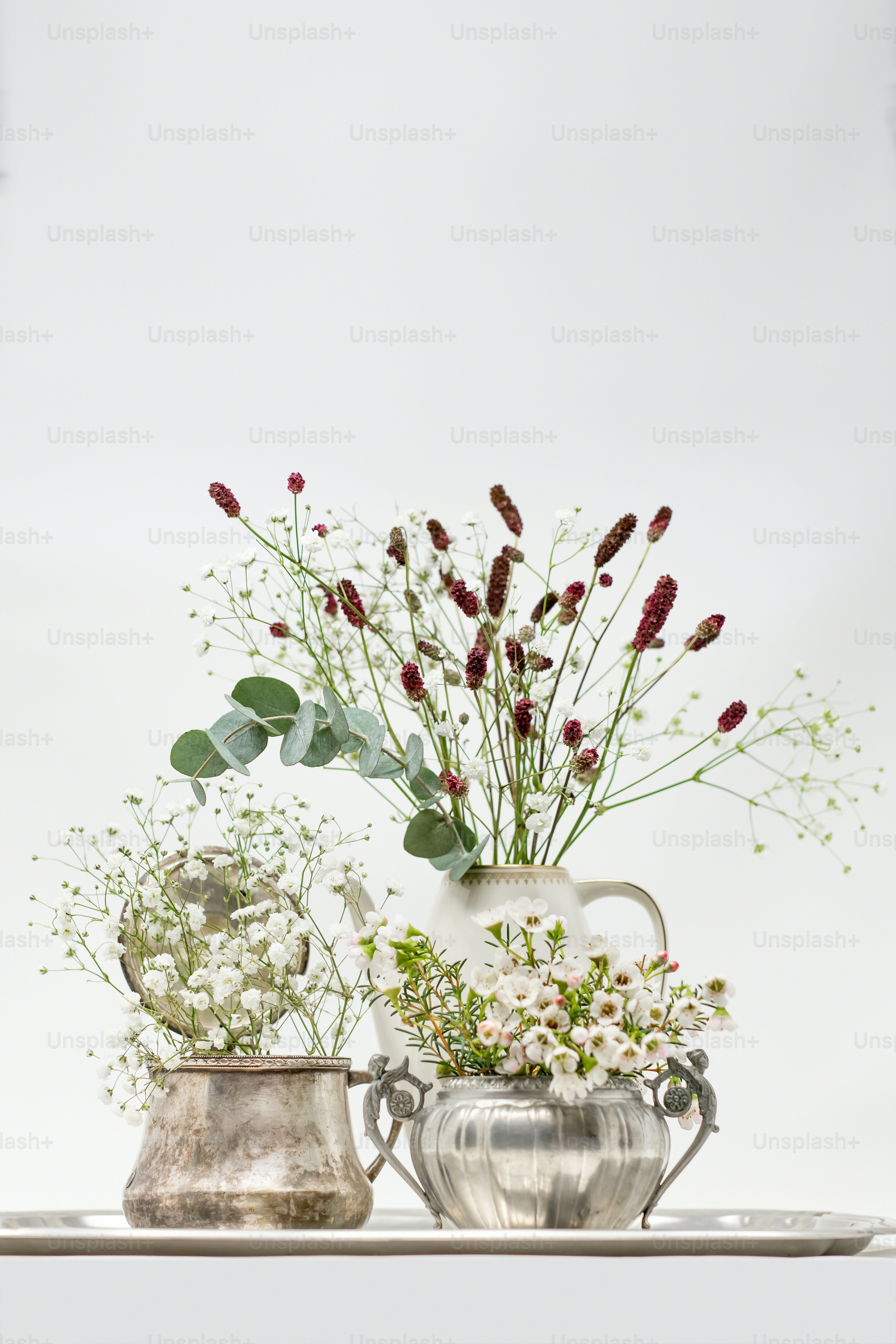 A vase filled with flowers on top of a wooden table photo – Flowers ...