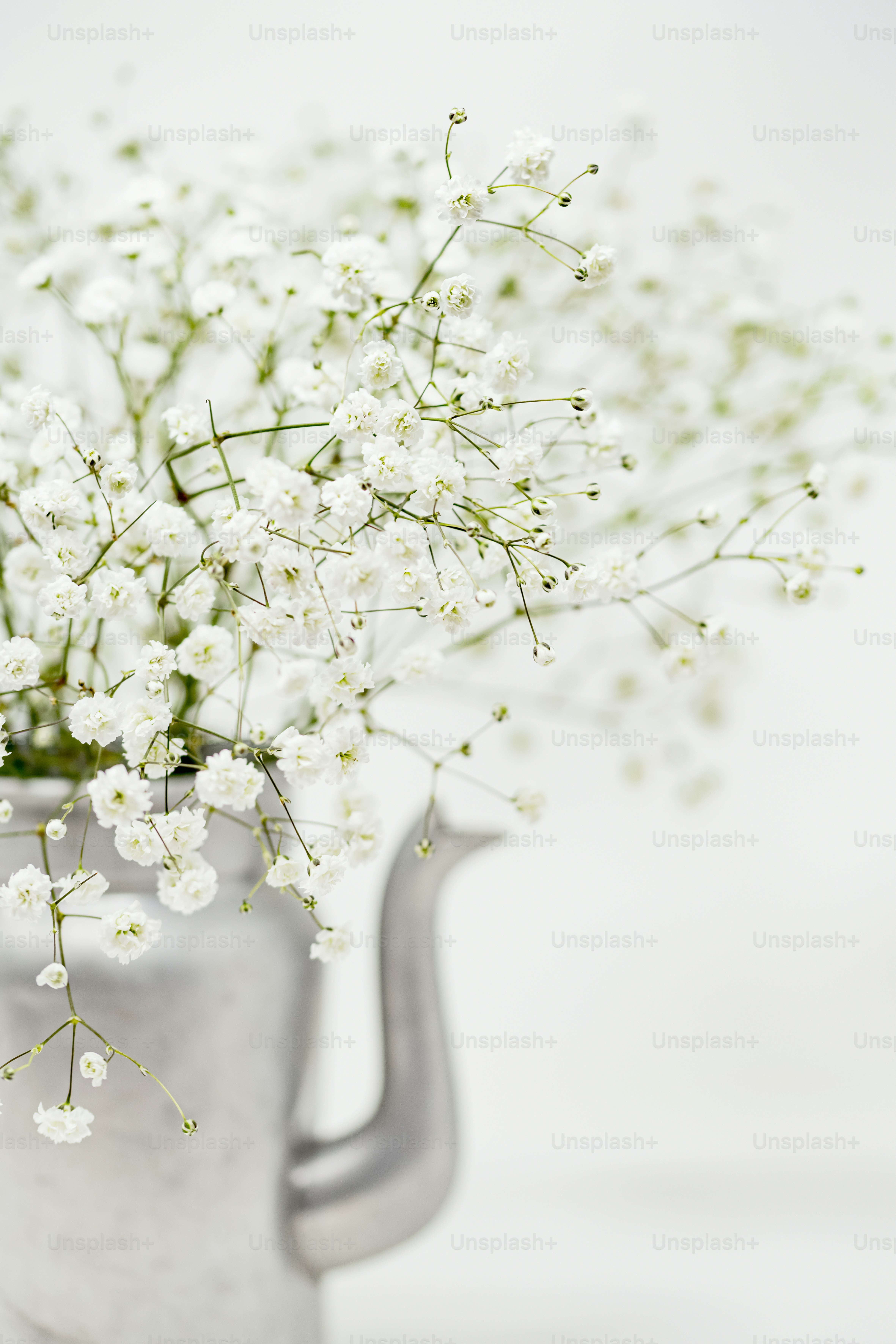 a vase filled with white flowers on top of a table