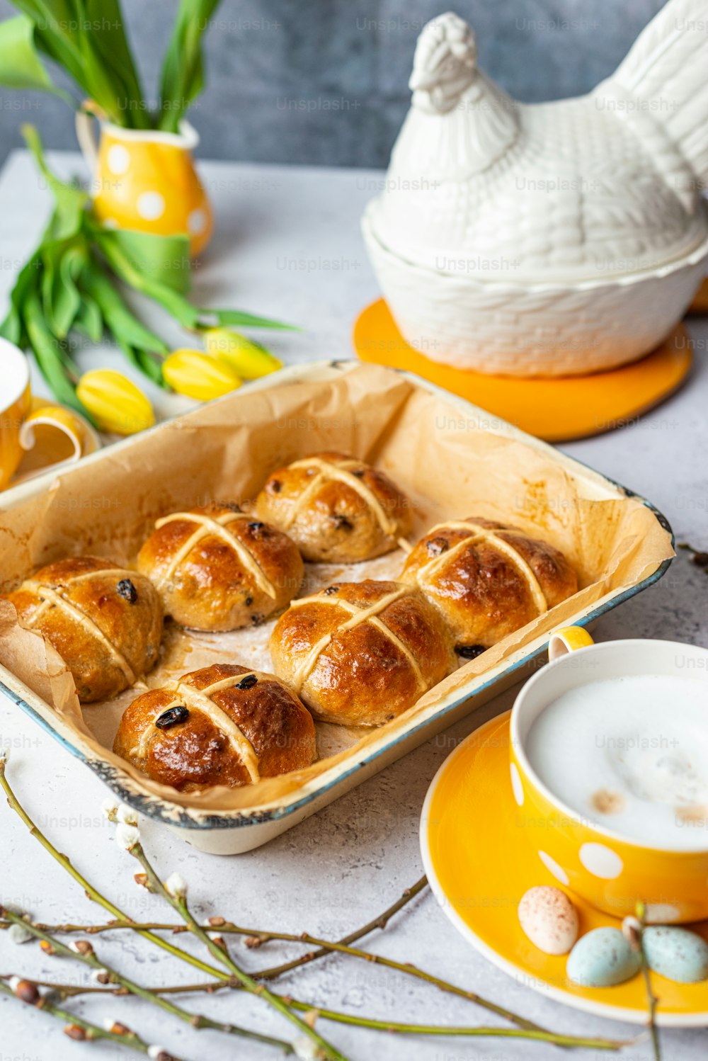 a pan of hot cross buns on a table