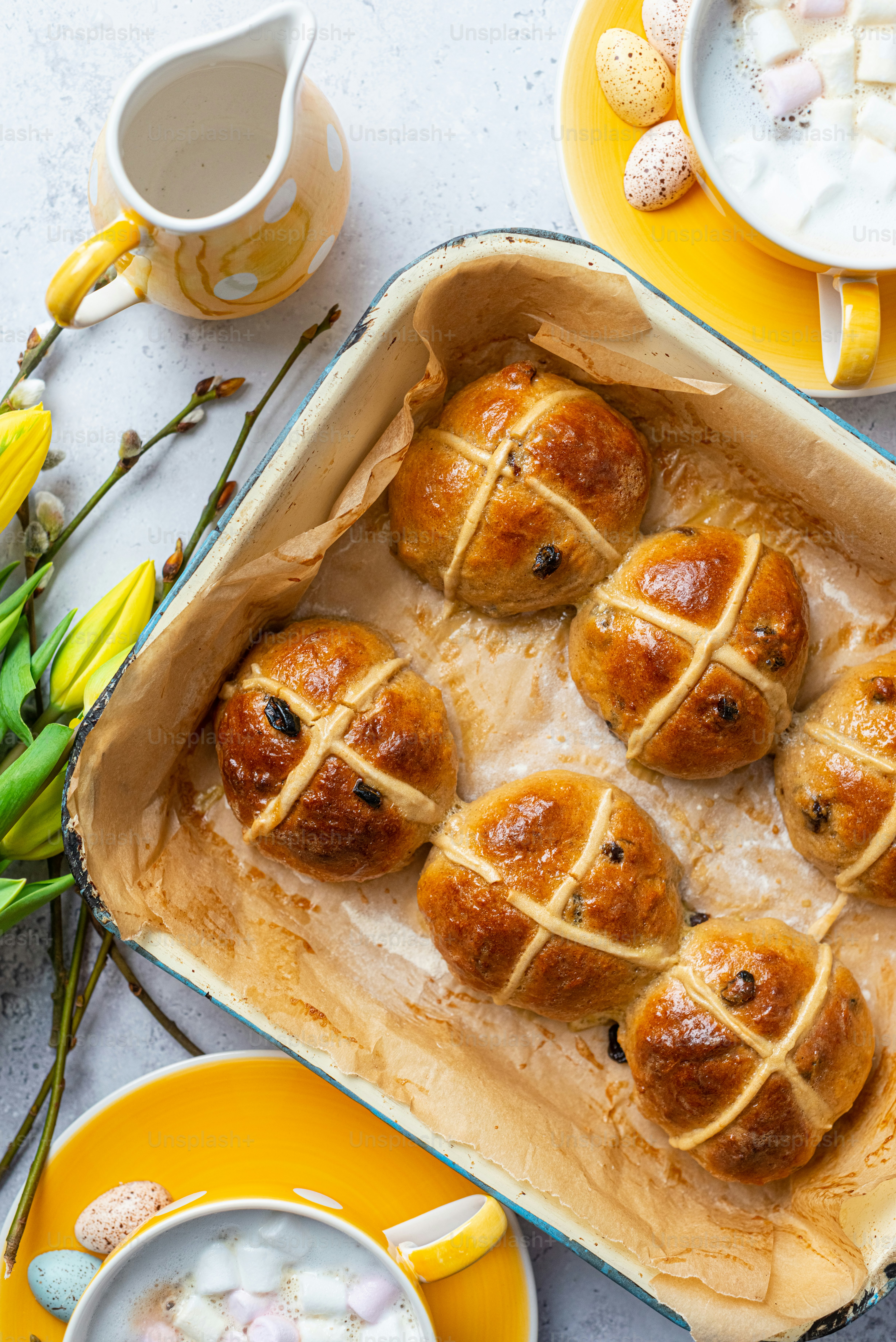 a pan filled with hot cross buns on top of a table
