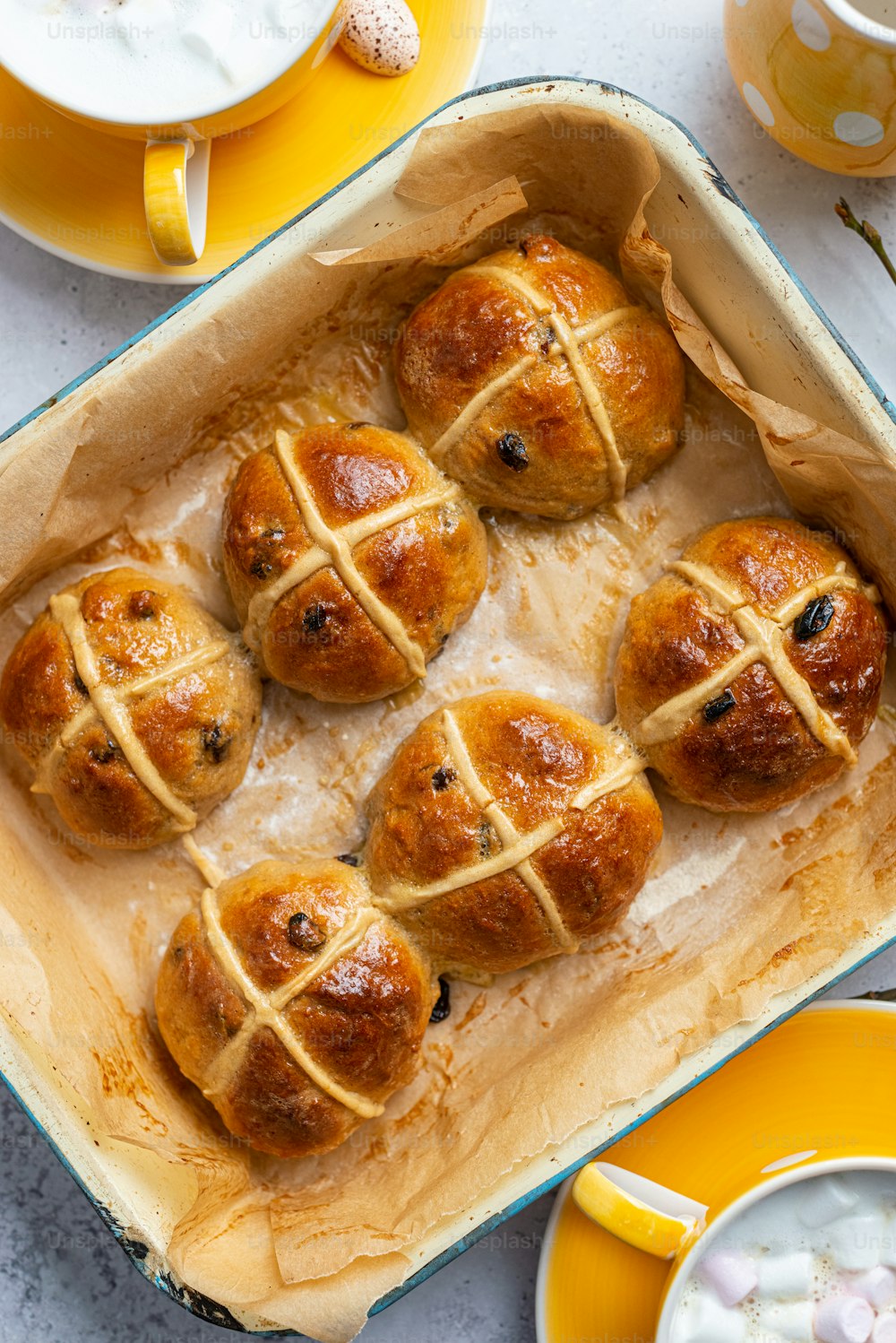 a baking pan filled with hot cross buns