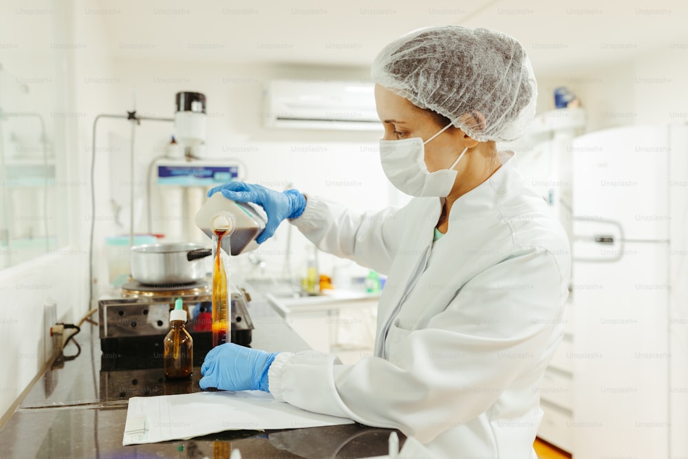 a woman in a white lab coat and blue gloves
