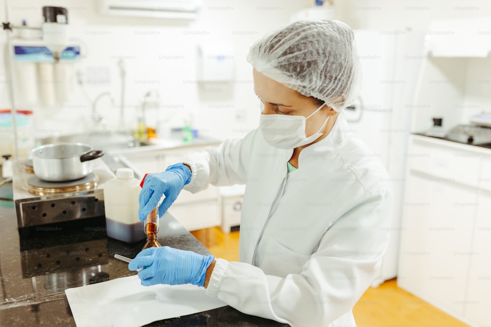 a woman in a white lab coat and blue gloves