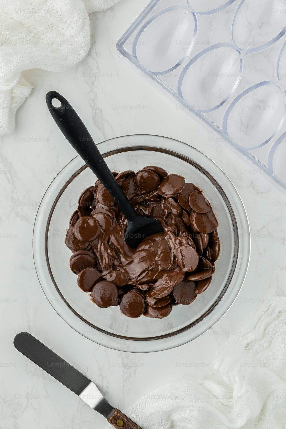 a bowl of chocolate chips with a spoon in it