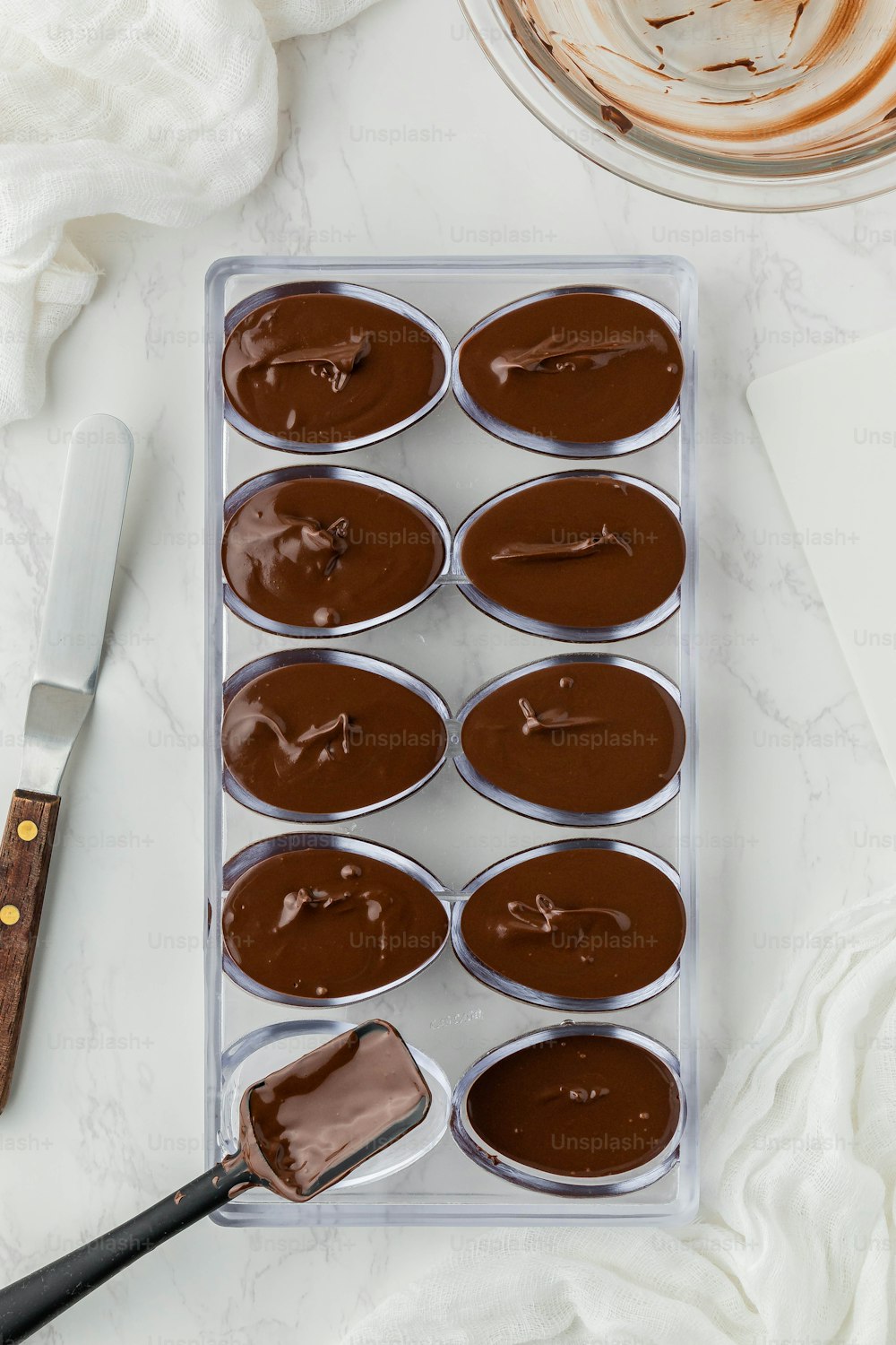 a tray of cupcakes with chocolate frosting