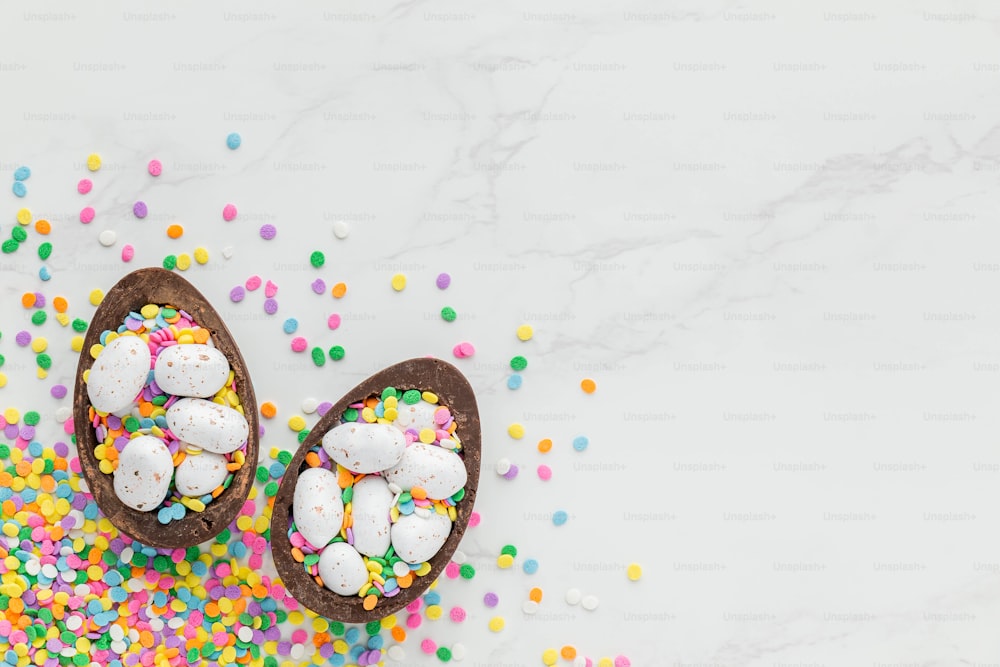 a pair of chocolate easter eggs filled with sprinkles