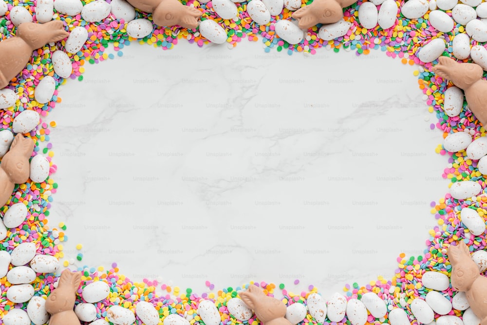 a group of hands holding candy and sprinkles