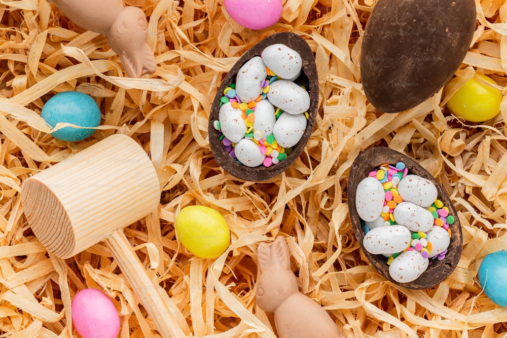 a pile of fake eggs sitting on top of a pile of straw