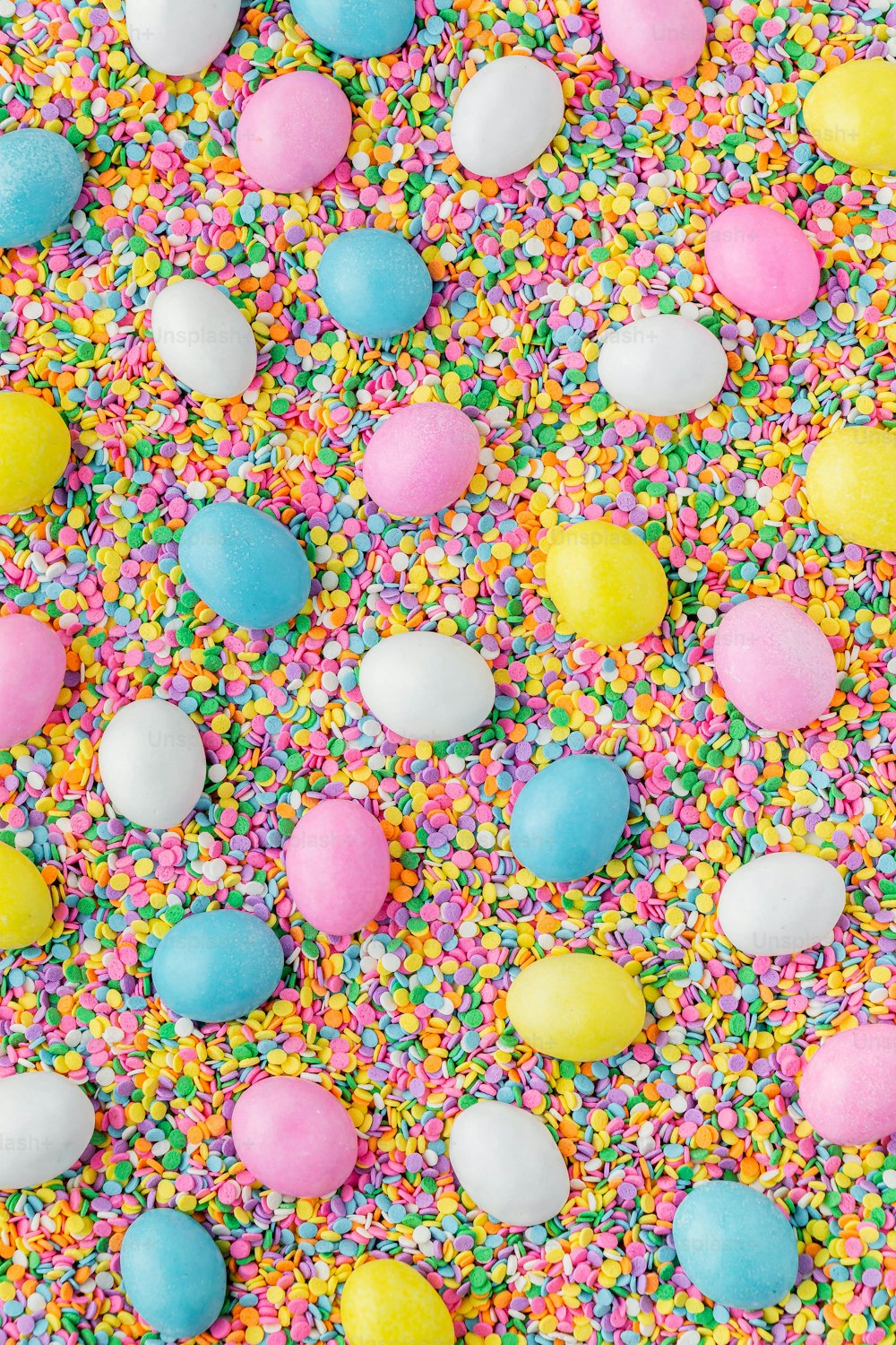 colorful sprinkles and eggs on a table