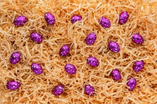 a close up of a bunch of purple candy eggs