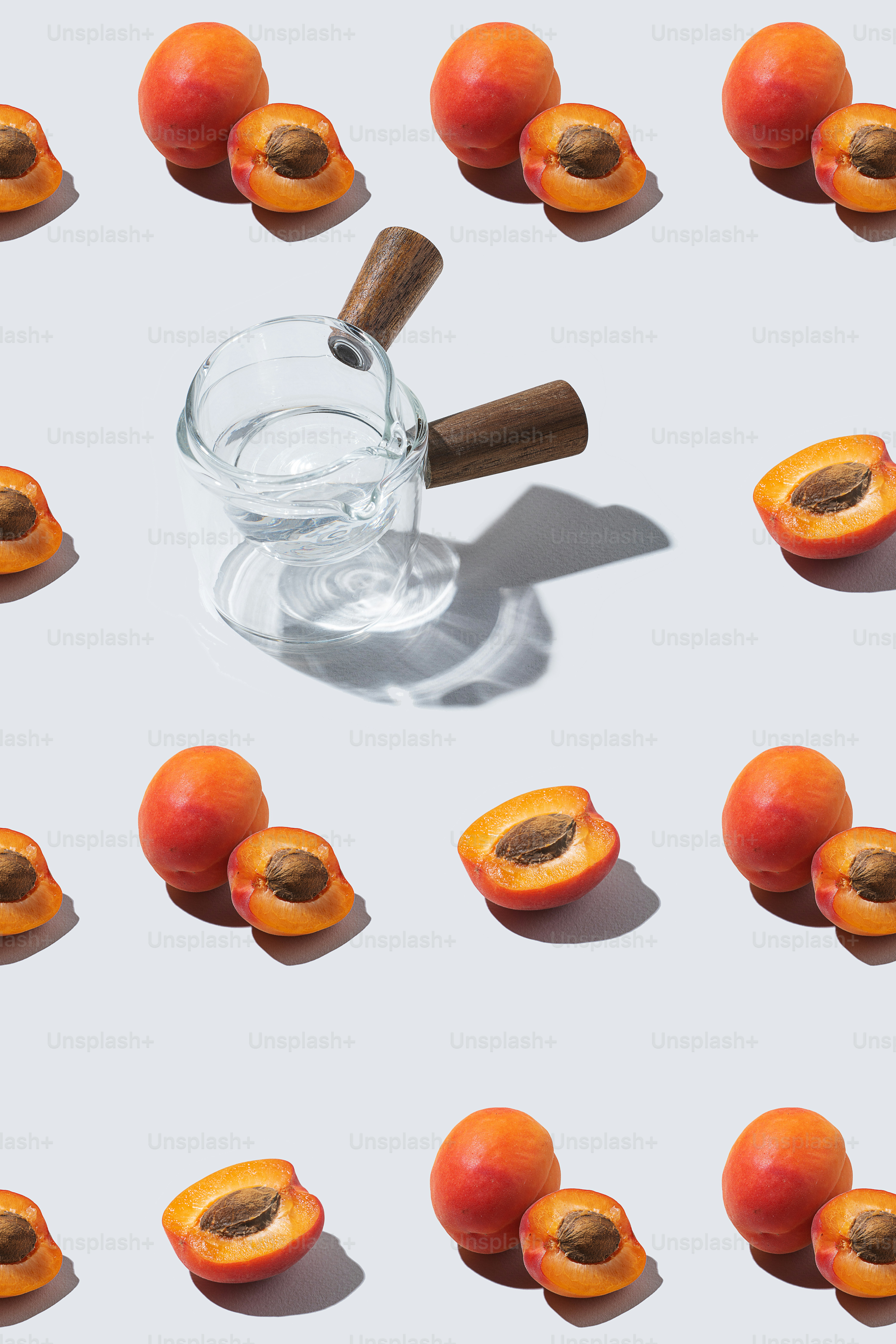 a glass of water surrounded by pieces of fruit