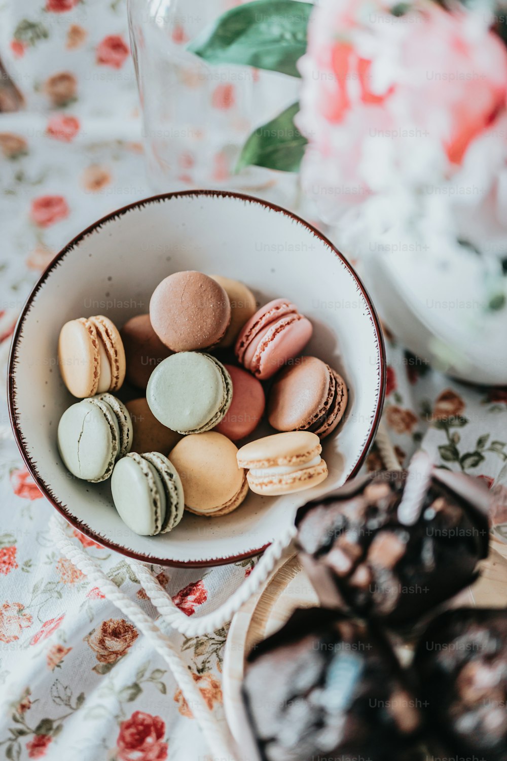 a bowl of assorted macaroons on a table