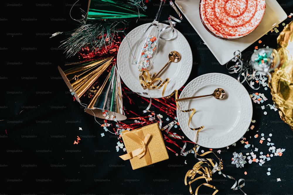 a table topped with plates of food and confetti