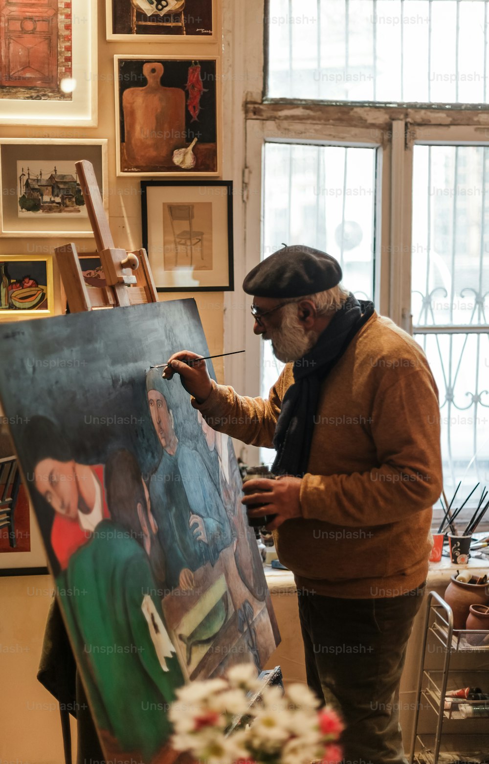 a man is painting a picture on a easel