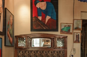 a picture of a woman on a wall above a fireplace