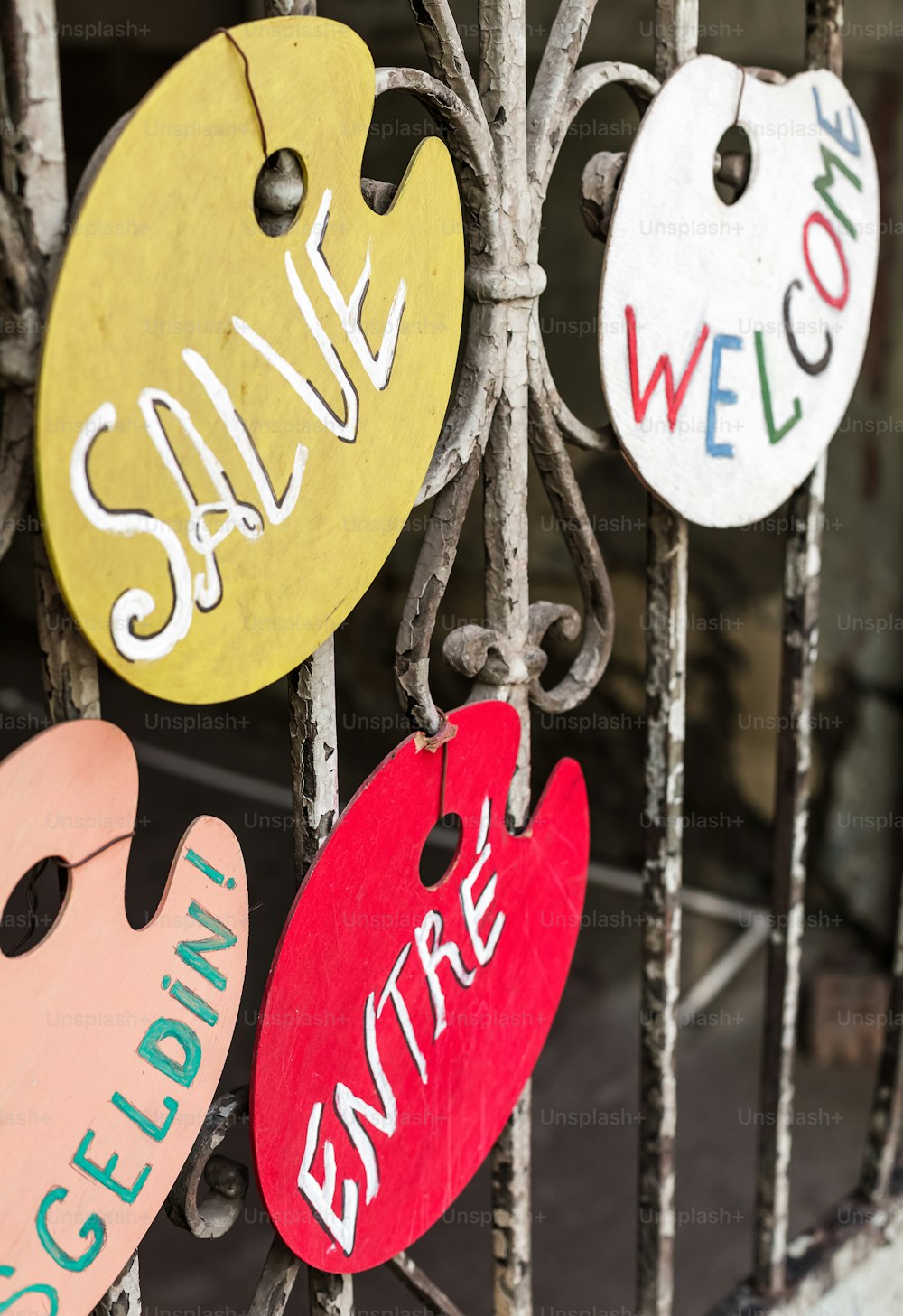 a bunch of signs that are hanging on a fence