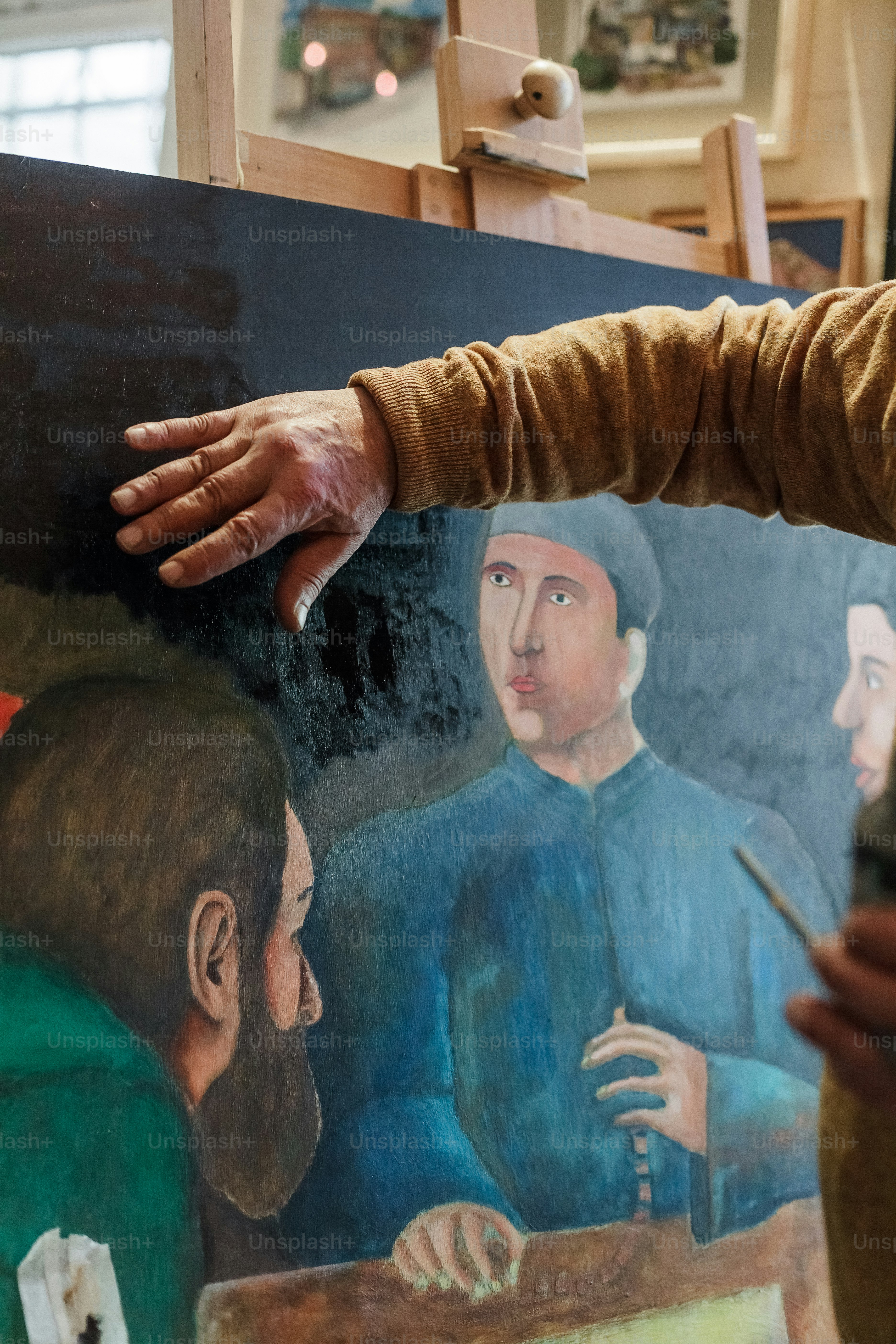 a man is painting a picture of a man with a beard