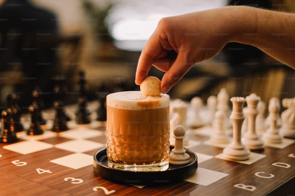 a person placing a piece of food on top of a chess board