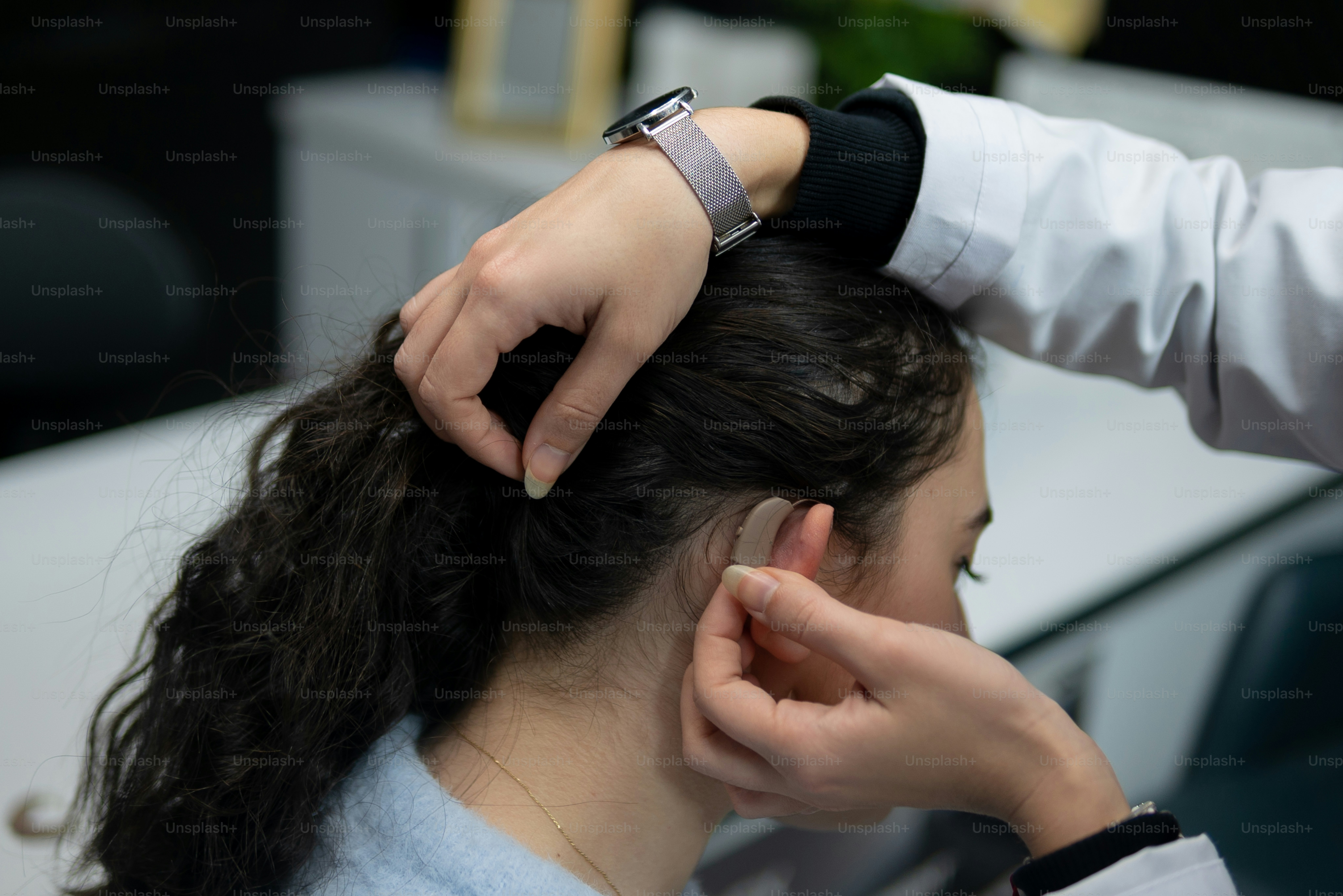 a woman getting her hair styled by a hair stylist