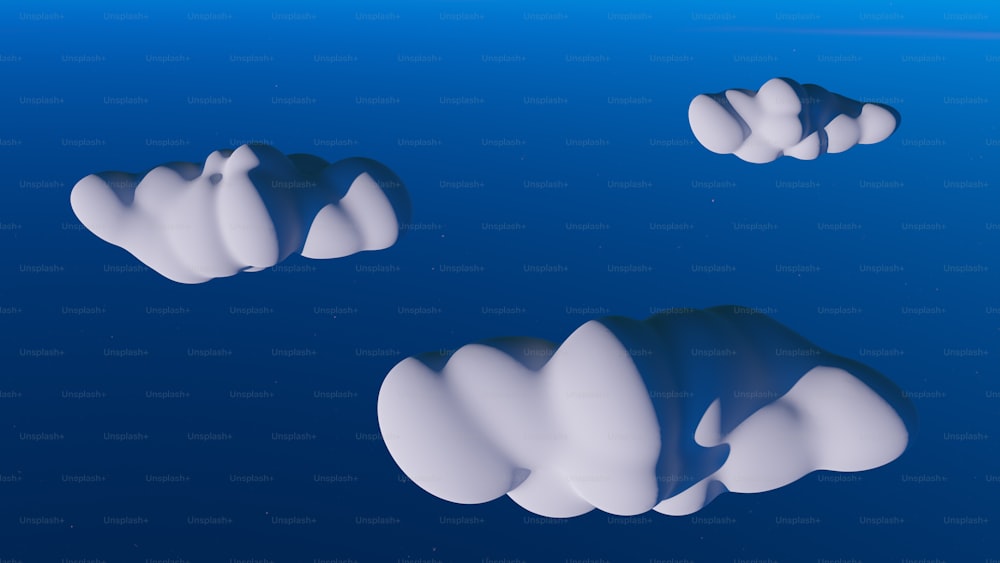 Un gruppo di nuvole bianche che galleggiano sulla cima di una superficie blu