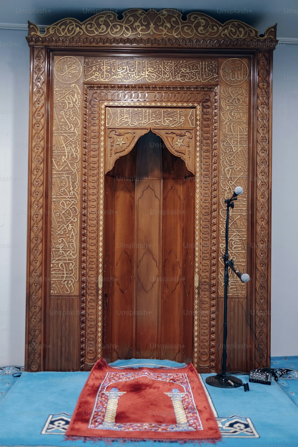 a wooden door with a red rug in front of it