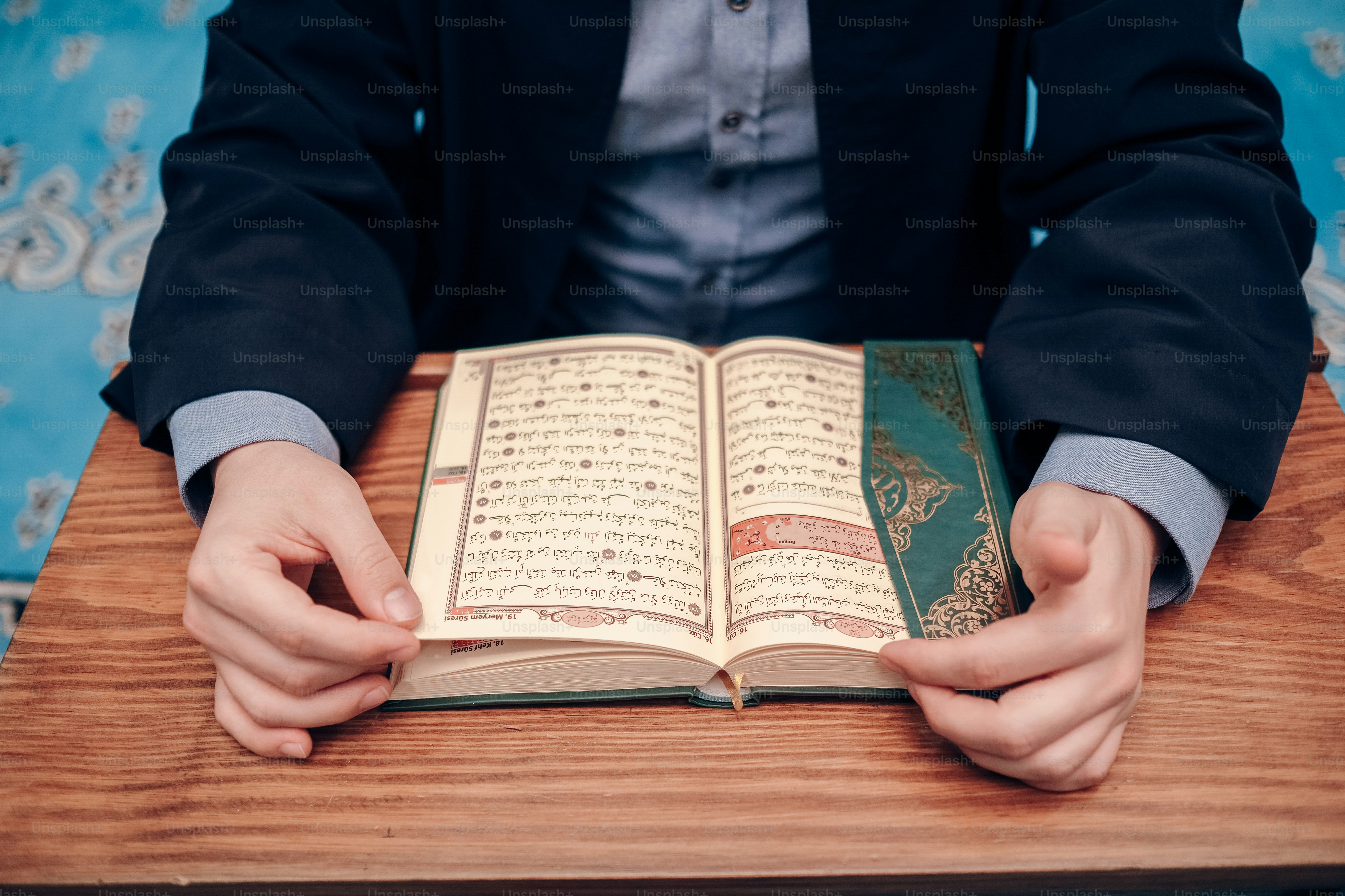 a person sitting at a table with an open book