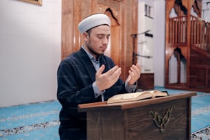 a man in a turban sitting at a podium