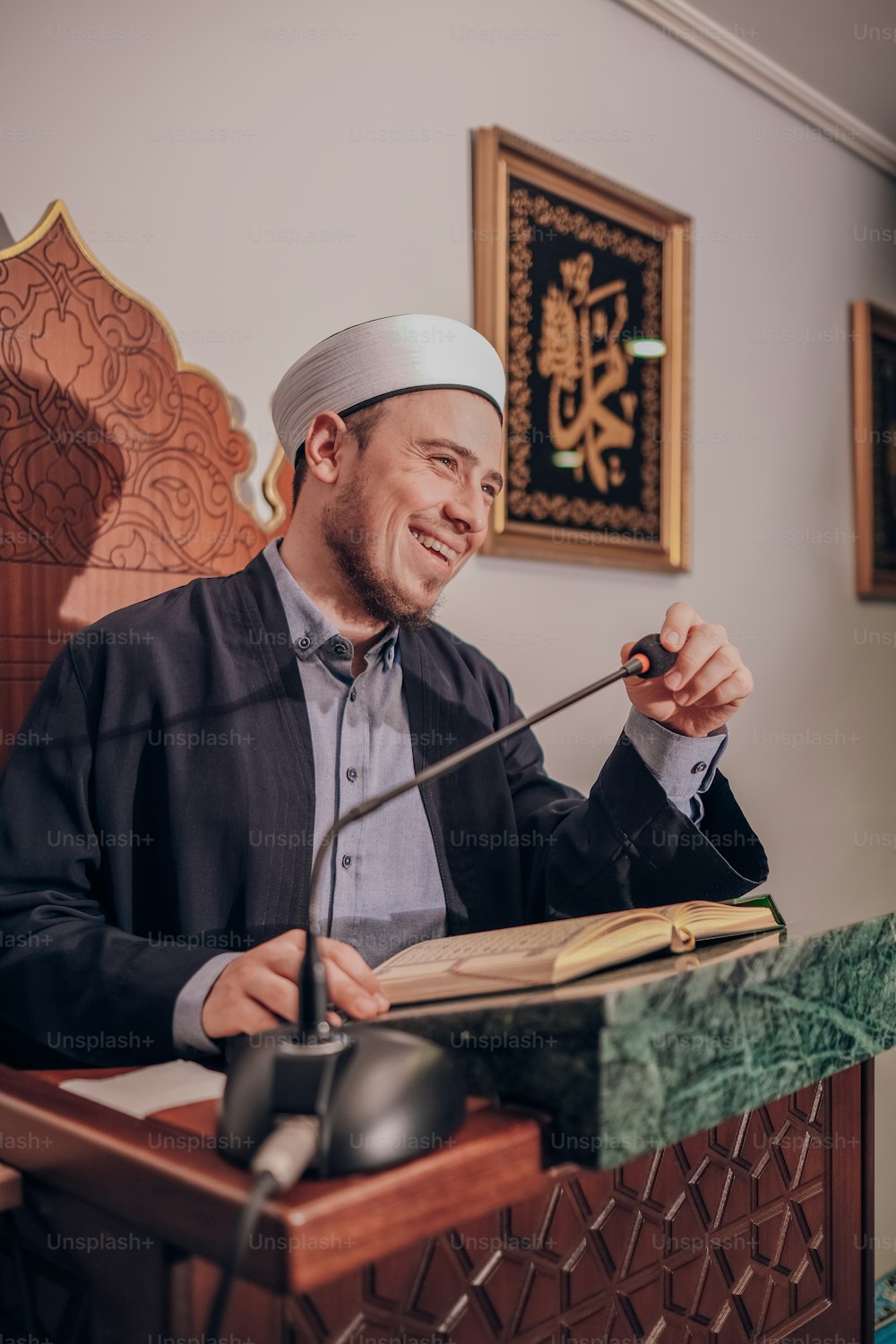 a man sitting at a table with a book in his hand