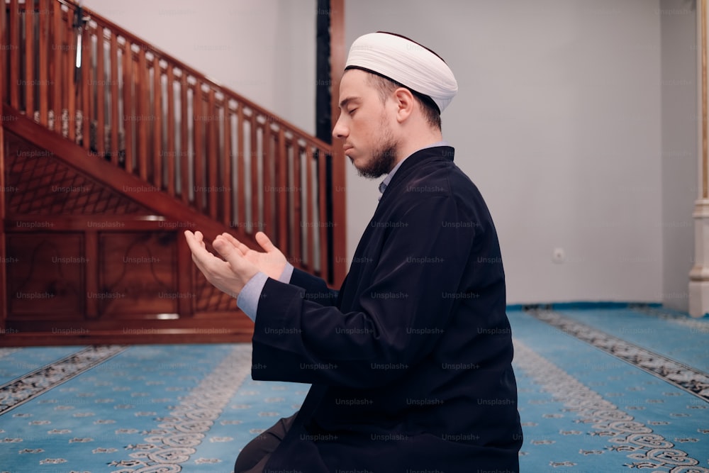 a man sitting on the floor in front of a stair case