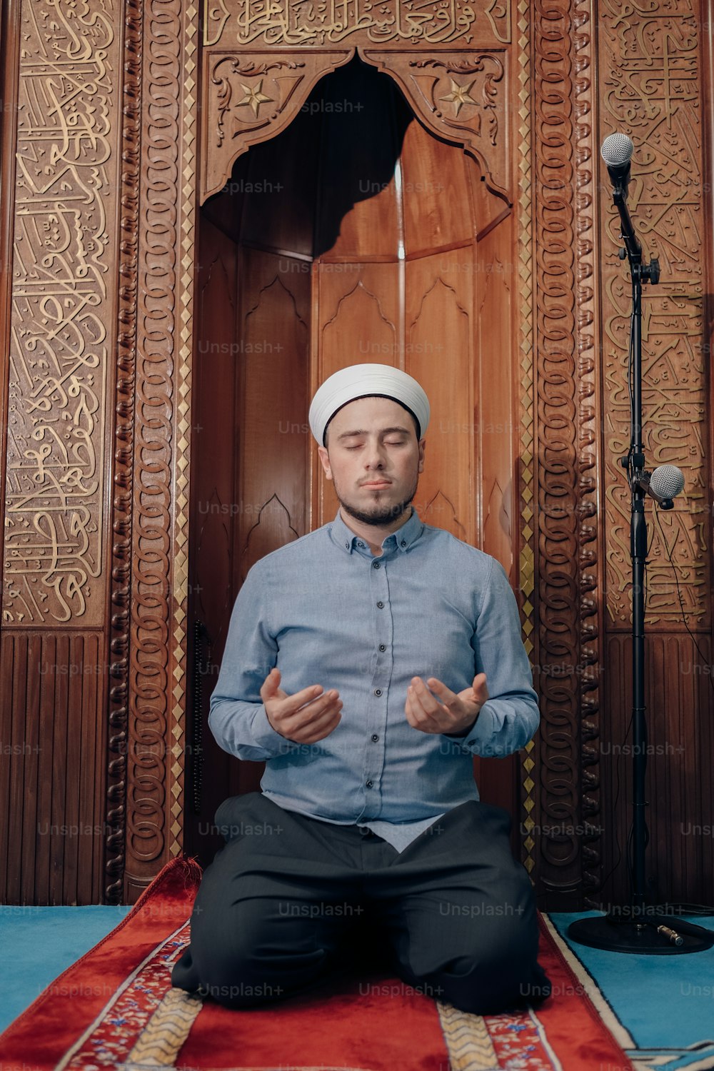 a man sitting on a rug in front of a wooden door