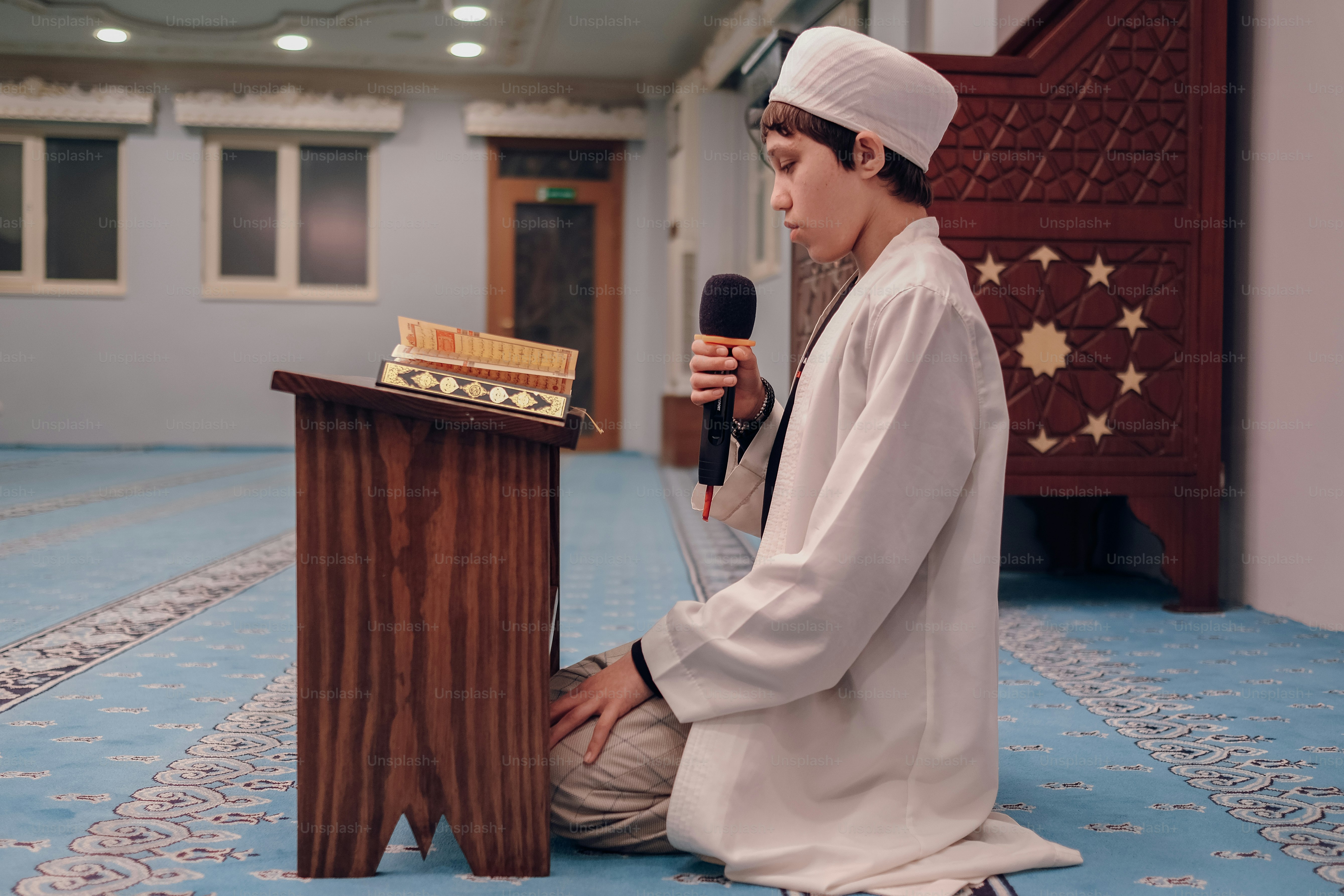 a man sitting on the floor with a microphone
