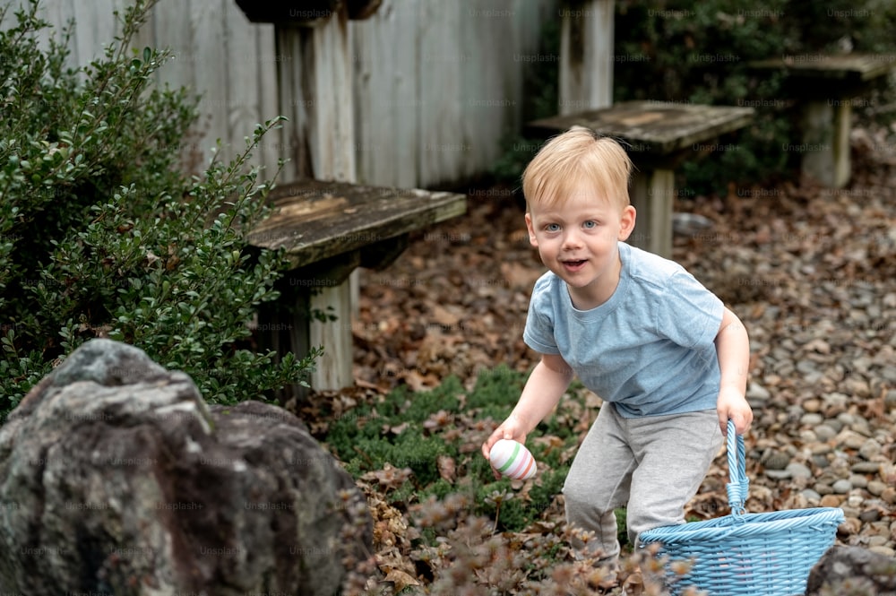 a young boy holding a blue basket and a white frisbee