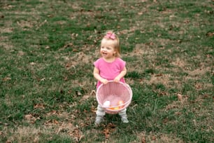 a little girl holding a basket full of oranges