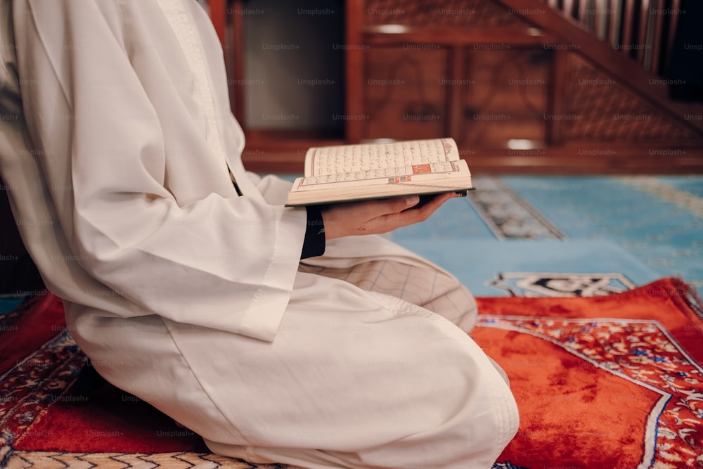 a person sitting on a rug holding a keyboard