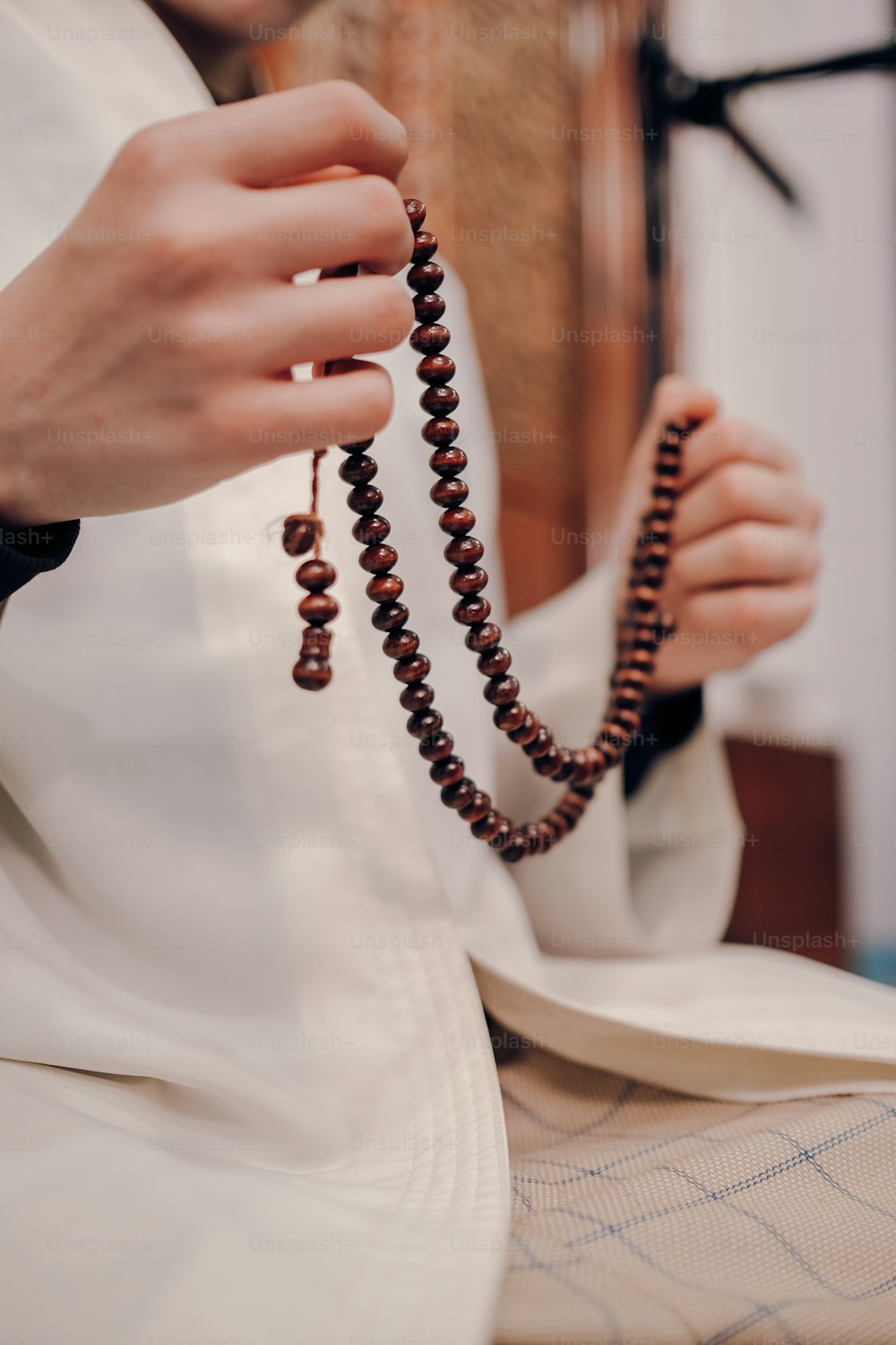 a person holding a rosary in their hands