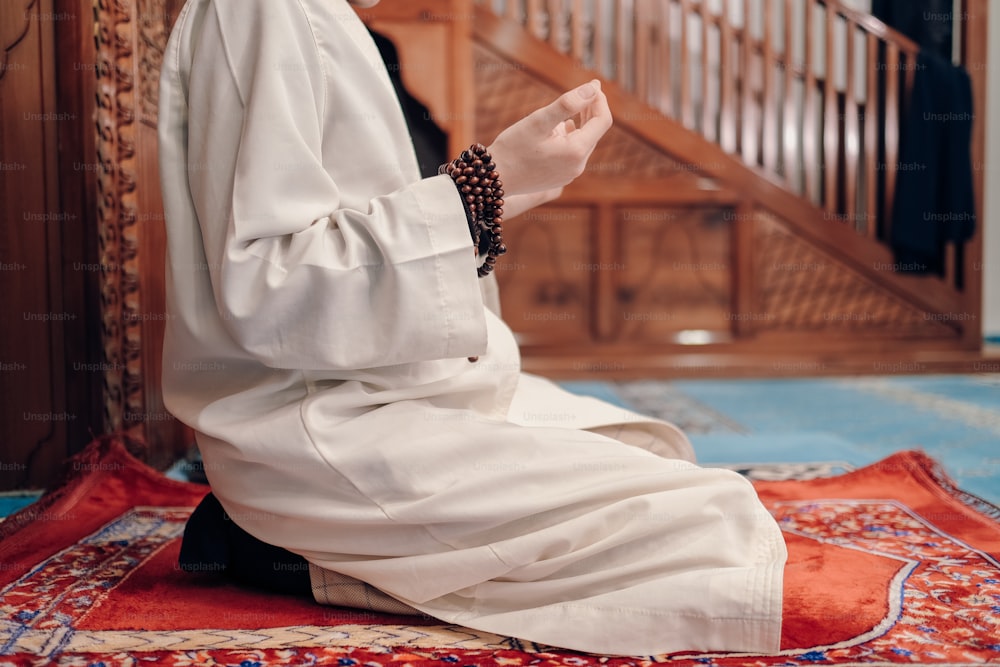 a person sitting on a rug in a room