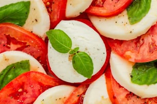 a close up of sliced tomatoes and basil