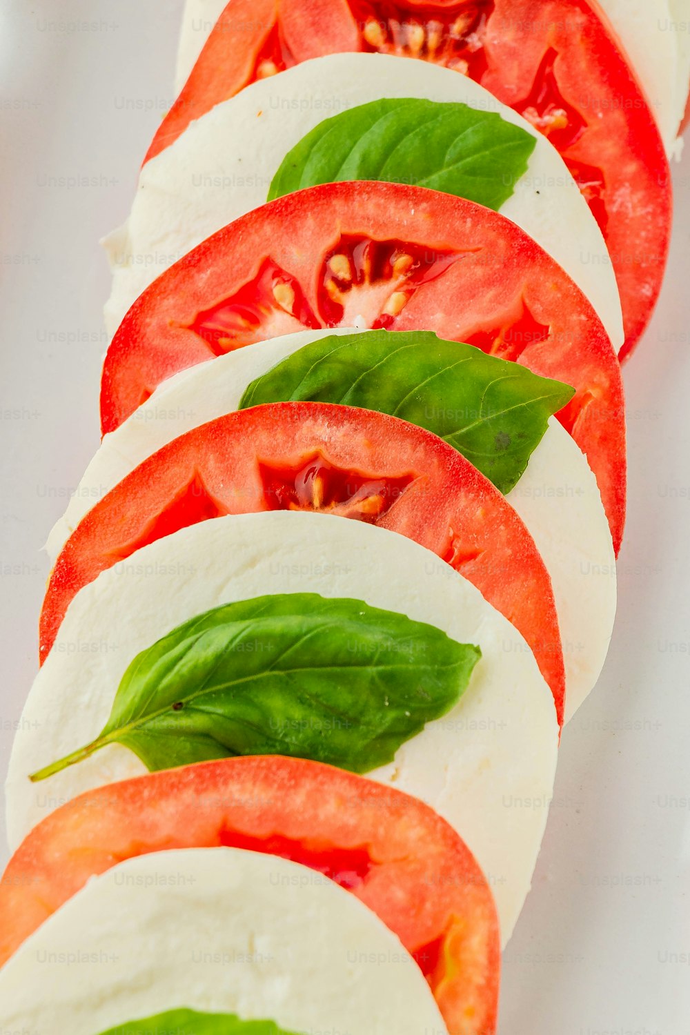 a close up of sliced tomatoes and mozzarella