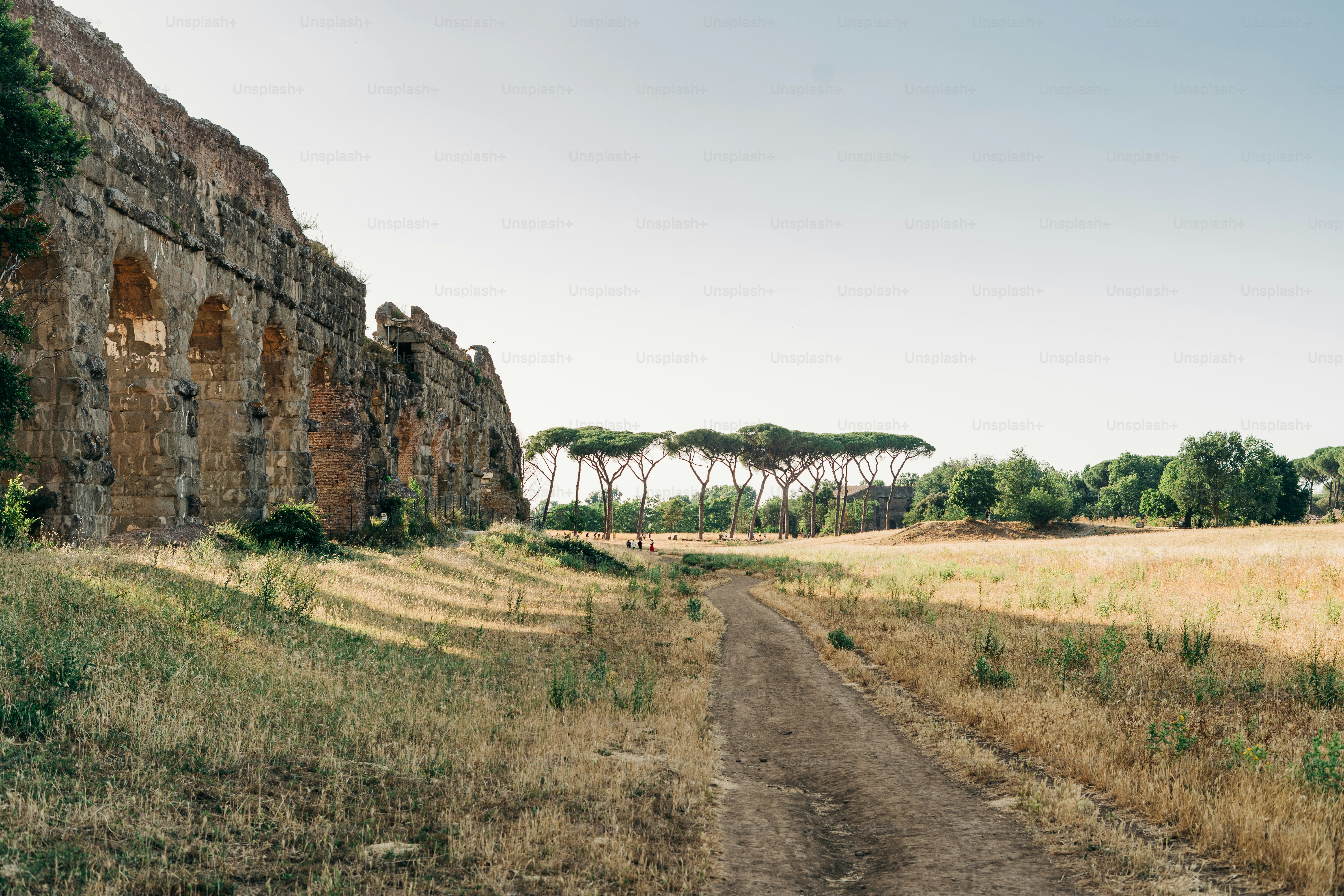 a dirt road in front of an old building