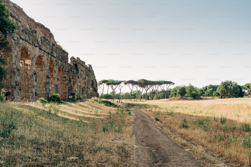 a dirt road in front of an old building