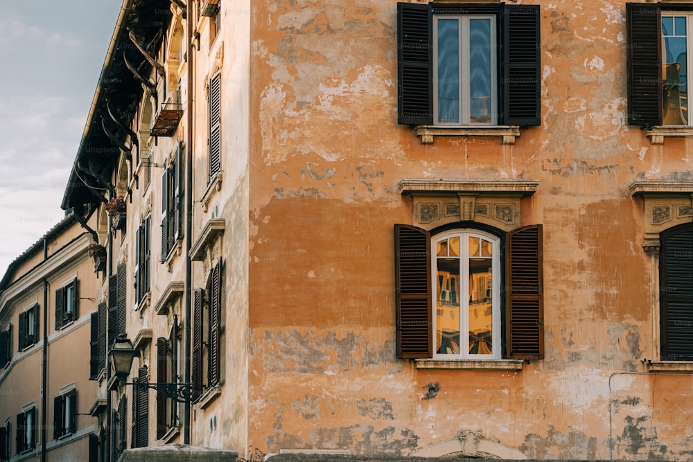 an old building with two windows and shutters