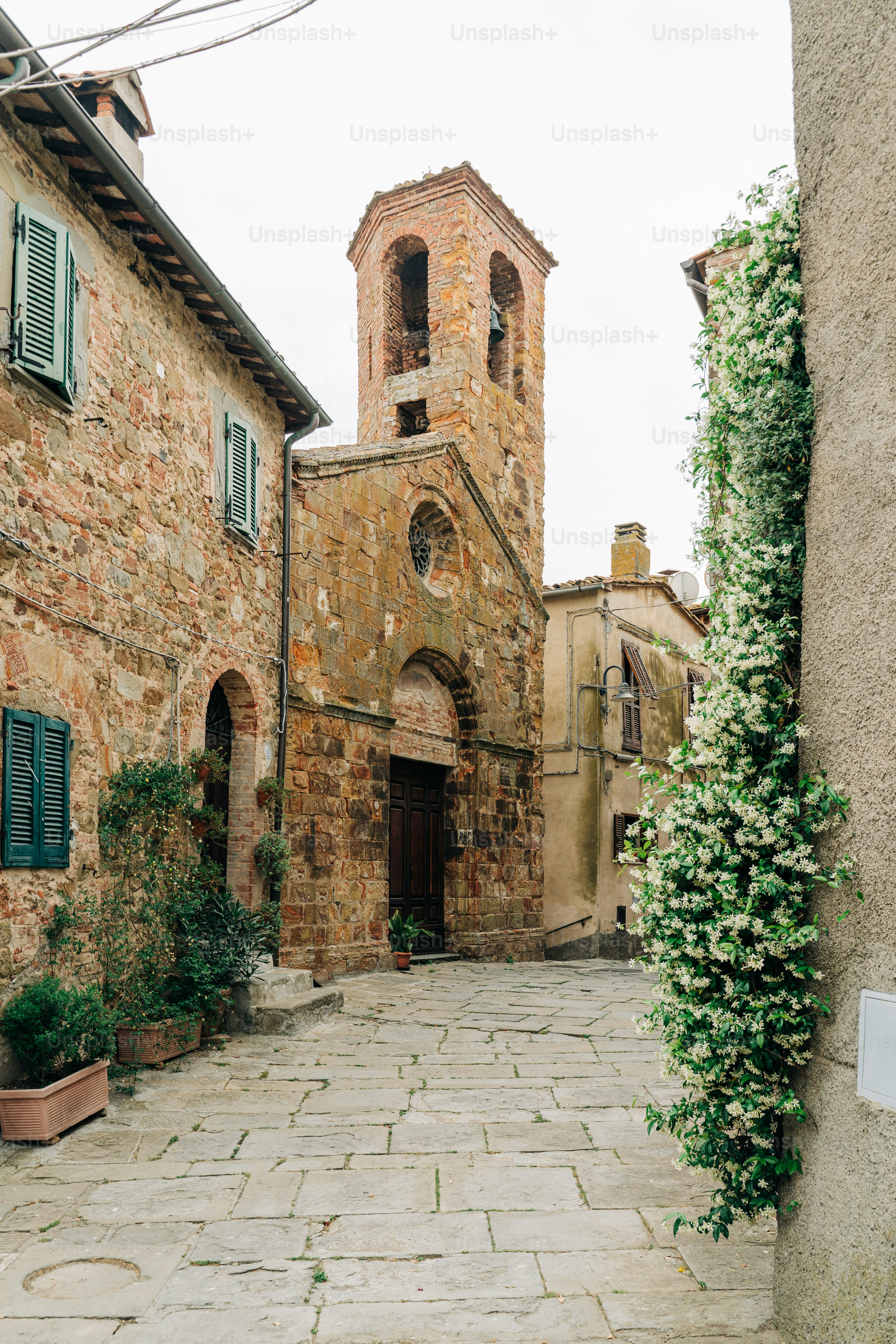 a cobblestone street with a church in the background